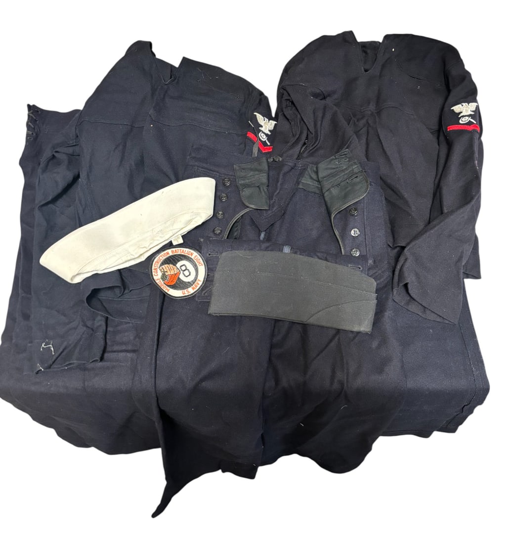 Post WWII US Navy Jumper Sets and Accessories: (3) USN Jumper Pants size 29R and 30R. (2) USN Jumper Tops Size 36 and 36R. (1) White Navy Sailor Cap. (1) Black/Navy Garrison Cap. (1) USN Patch for Mobile Construction Battalion Eight. (1) USN Navy