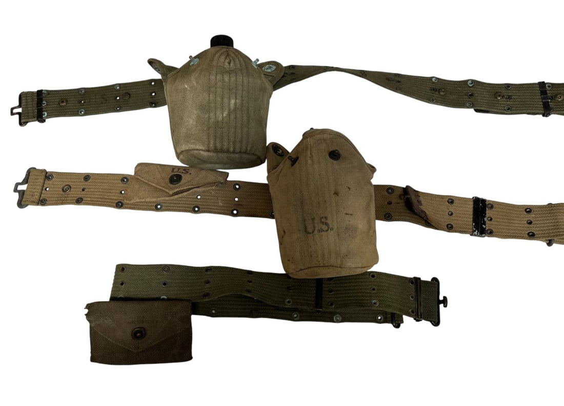 (3) WWII Belts with Miscellaneous Attachments: 1- Has a canteen case barely readable, but canteen is marked Vollrath 1945. Belt has text barely legible. Overall fair condition, 2- Has a pouch marked NS&WSMOE Co. 1942, canteen pouch marked Foley Mf