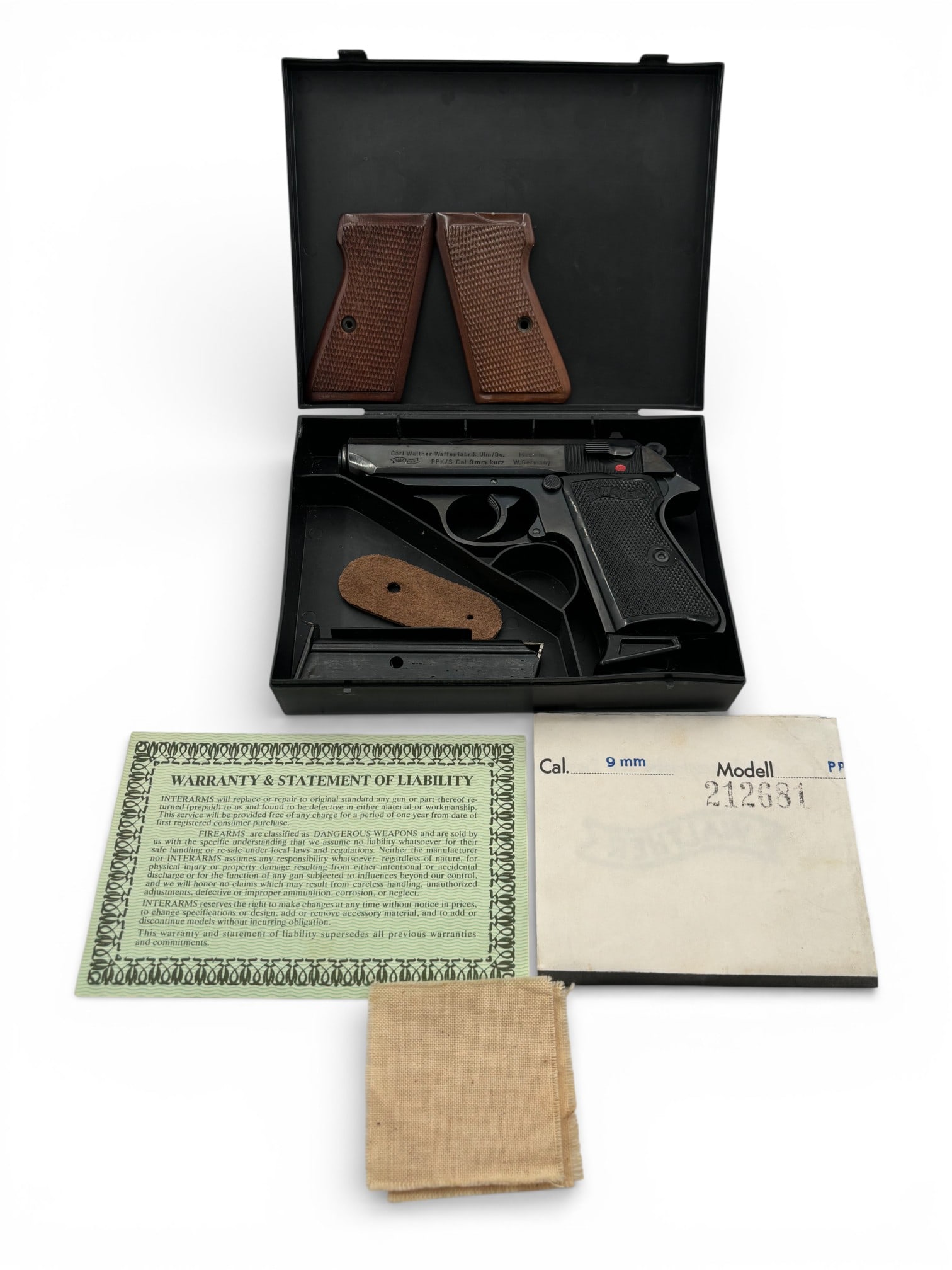 NIB Desirable 1976 West German Walther Model PPK/S .380 ACP Semi-Automatic Pistol: S#: 212681S, mfg. 1976 | Comes in factory hard case with matching label, warranty, paper target and (2) magazines. Also comes with a set of extra wood checkered grips and a leather tab ||||