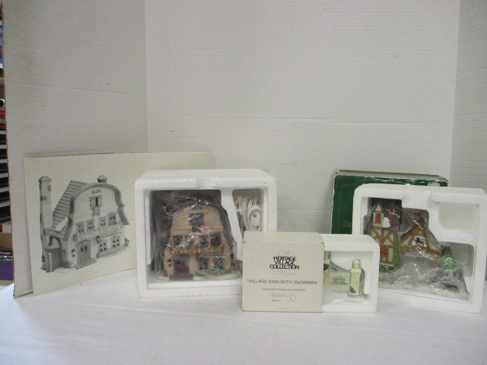 Dept. 56 Heritage Village Collection House and Accessories: Alpine Village Series "Metterniche Wurst" #5618-9(has light), "Village Signe with Snowman" #5572-7, Dickens' Village Series "Postern" #9871-0