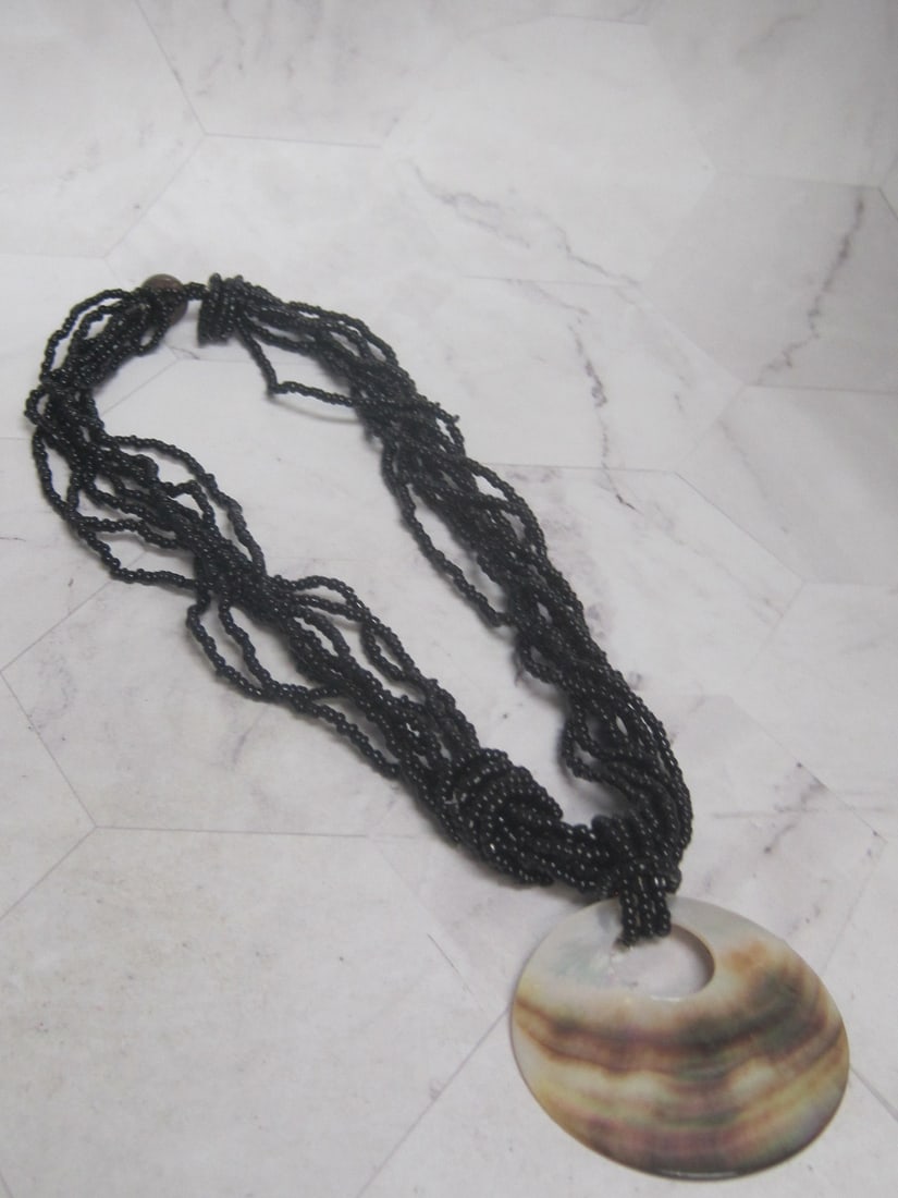 Multi-Strand Beaded Necklace with Mother of Pearl Disc Pendant: . 