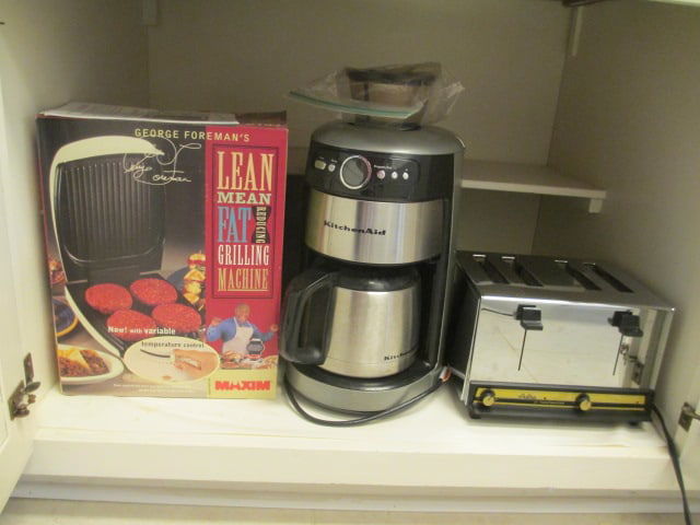 George Forman Grill in Original Box, KitchenAid Stainless Coffee Maker and Carafe: and Toastmaster Astra 4 Slice Toaster. All power on, Local Pickup Only 