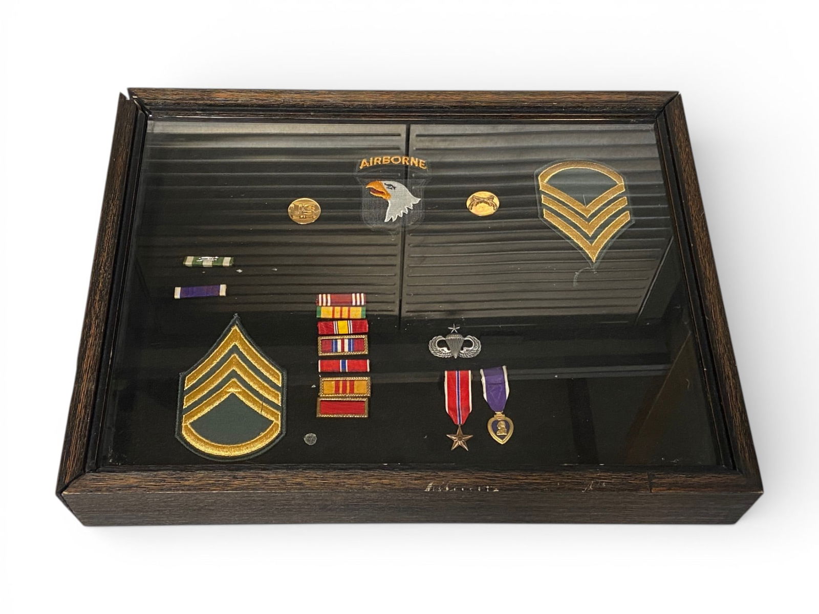 US 82nd Airborne Grouping in Shadow Box: Staff SGT Rank Patches, 82nd Airborne Patch, Jump Wings, Army Good Conduct, Bronze Star, Purple Heart, Brass Insignia, and More. See Photos |17.5"x13.5"x2.5" | *BUYER CAN DECIDE IF THEY WANT THE FRAME