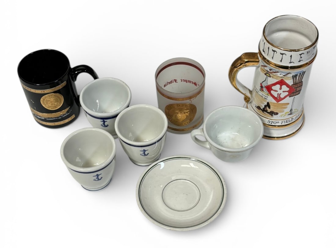 Lot of (8) Cup Items: Little Don 570th Field Artillery Missile Batallion Texas to Italy Mug, US Army Coffee Cup and Cup Plate, (3) Glass US Navy Cups, USS John C Stennis Coffee Mug, USMC Cup with Different Battles. See