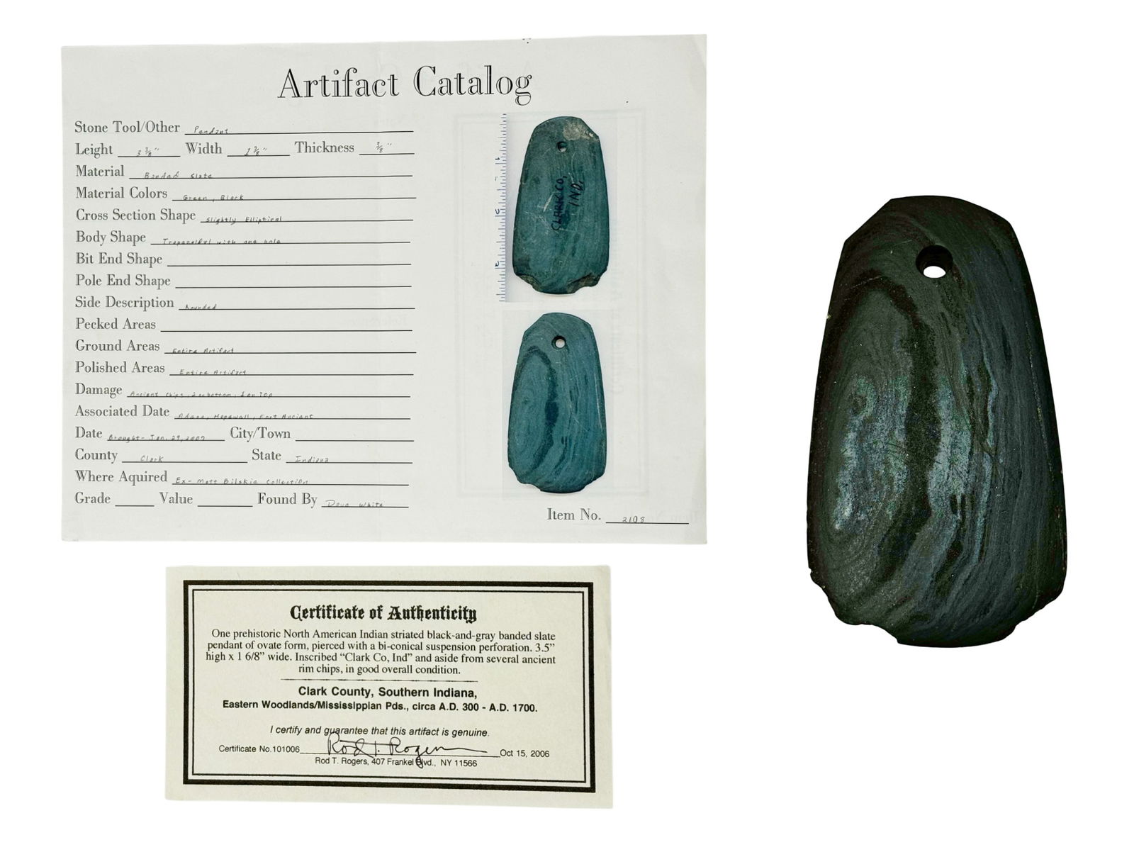 Excellent Clark Co. Indiana Prehistoric Banded Slate Trapezoidal Pendant with COA: Originated in Clark Co., Indiana. Rounded sides. Green/black/gray color. Comes with certificate of authenticity and artifact catalog. This is a prehistoric North American Indian striated slate
