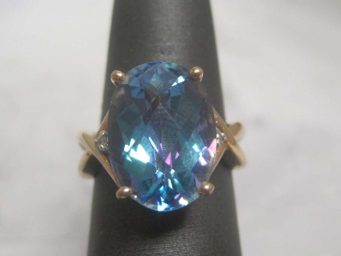10k Gold Blue Mystic Topaz & Diamond Ring: Weighs 5 grams, Size 5 1/2, Unusual oval gem, approximately 5 carats, Round diamond on each side 