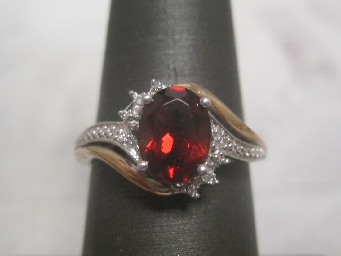 10k Gold & Sterling Silver Garnet & Diamond Ring: Weighs 3 grams, Size 6 3/4, Rich oval gem highlighted by small diamonds 