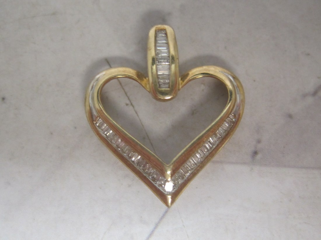 10k Gold Diamond Heart Pendant: Weighs 2 grams, 7/8", Loaded with baguette shaped diamonds, approx. 1 carat 