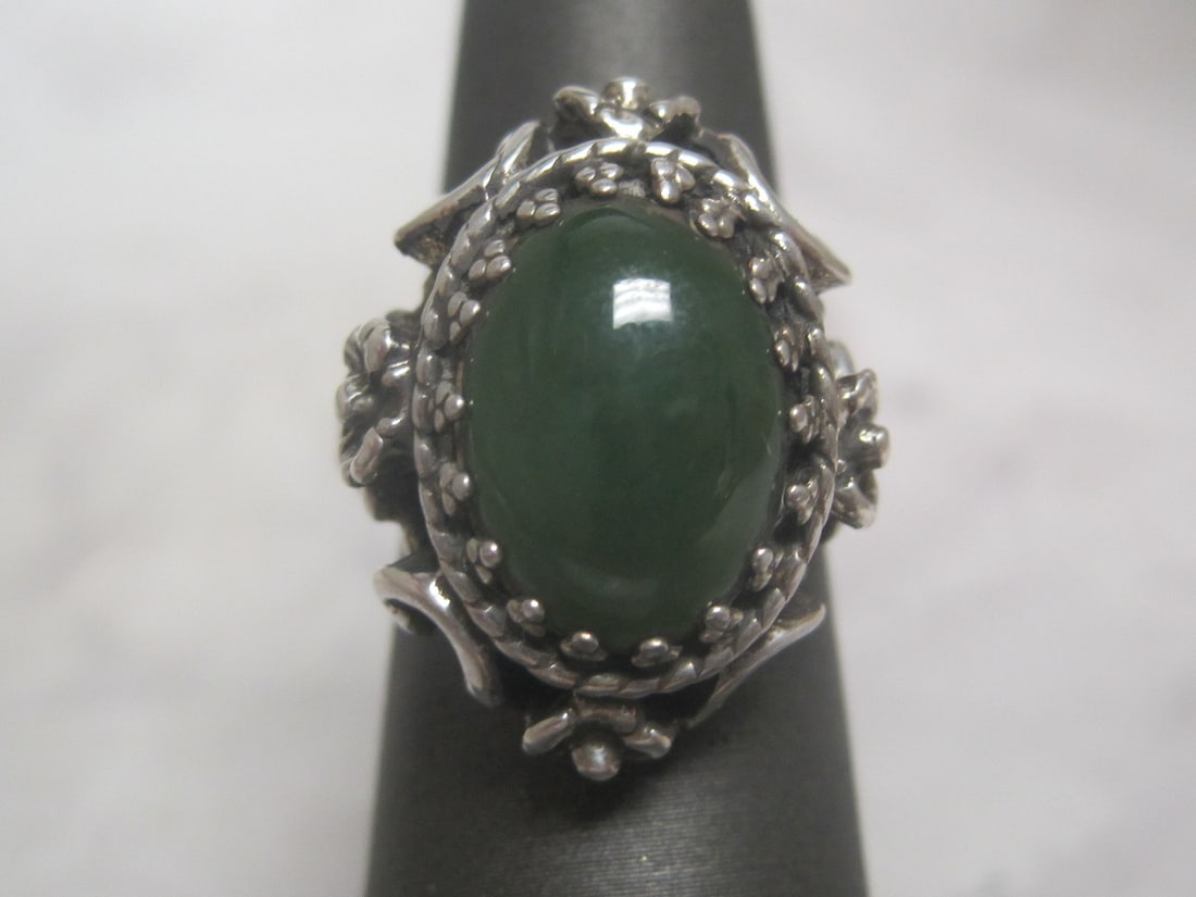 Sterling Silver & Jade Ring: Weighs 9.2 grams, Adjustable size- currently 6 1/2, Fine cabochon cut in fancy sterling openwork