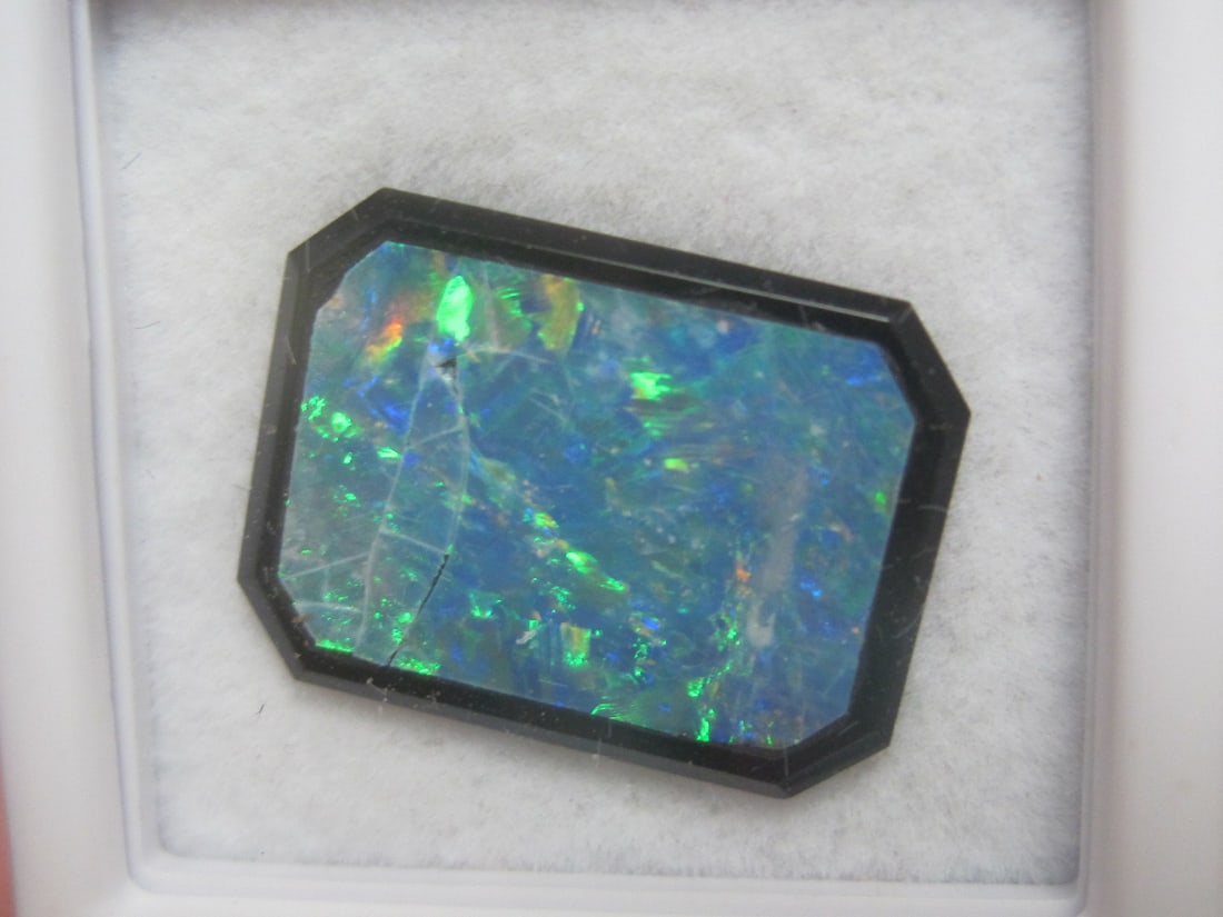 Black Opal Doublet: 4.6 carats total, 16x12mm, fiery gemstones on black background 