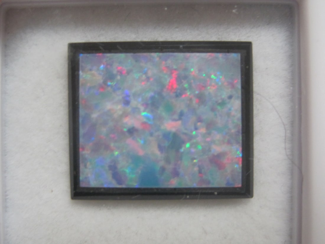 Black Opal Doublet: 3.6 carats total, 14x12mm, fiergy gem with rainbow of colors on black background 