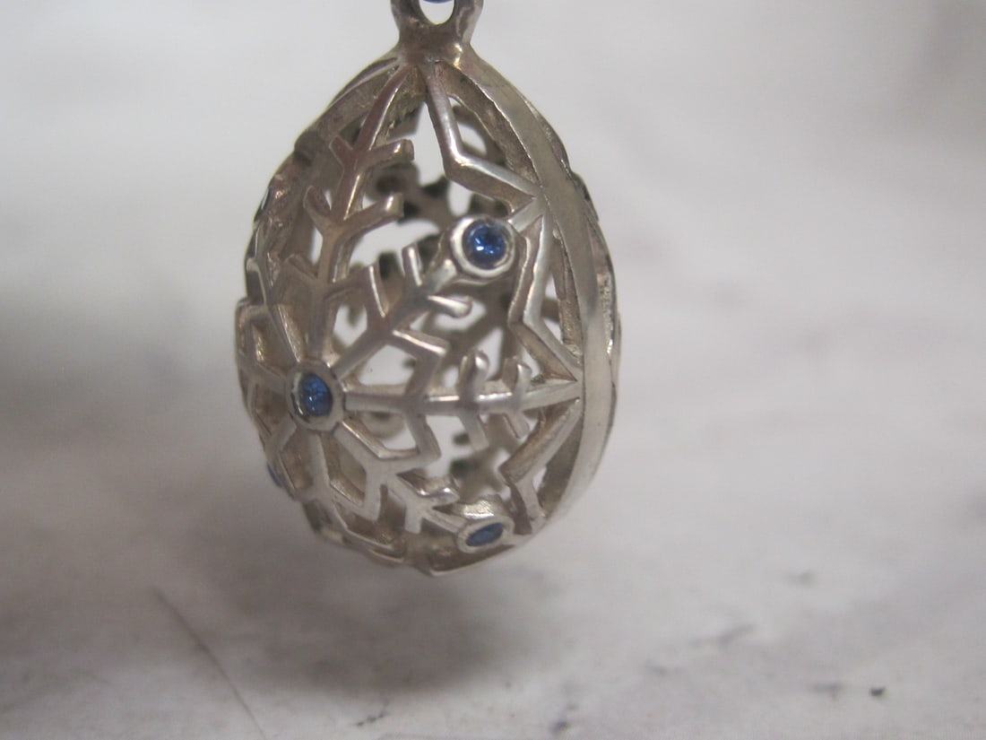 Sterling Silver Egg Shape Pendant: Weighs 4.3 grams, Blue stones in fancy openwork 