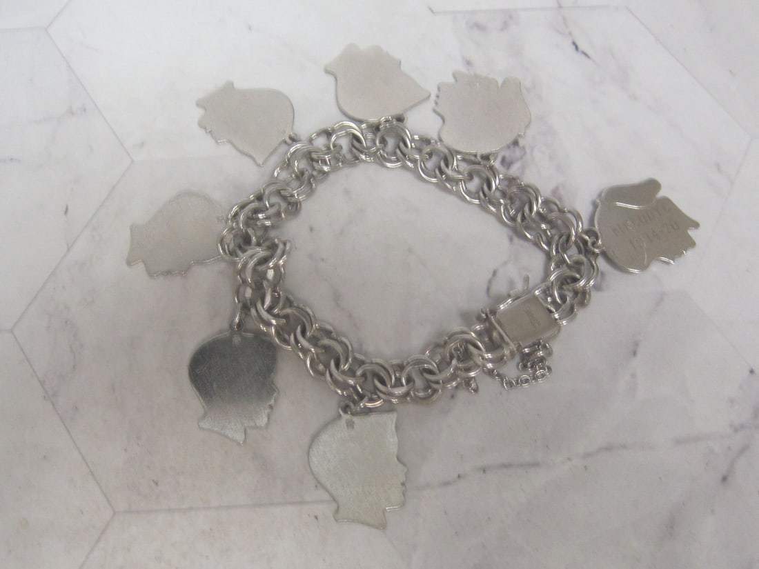 8" Sterling Silver Charm Bracelet with Charms: Weighs 39.6 grams 