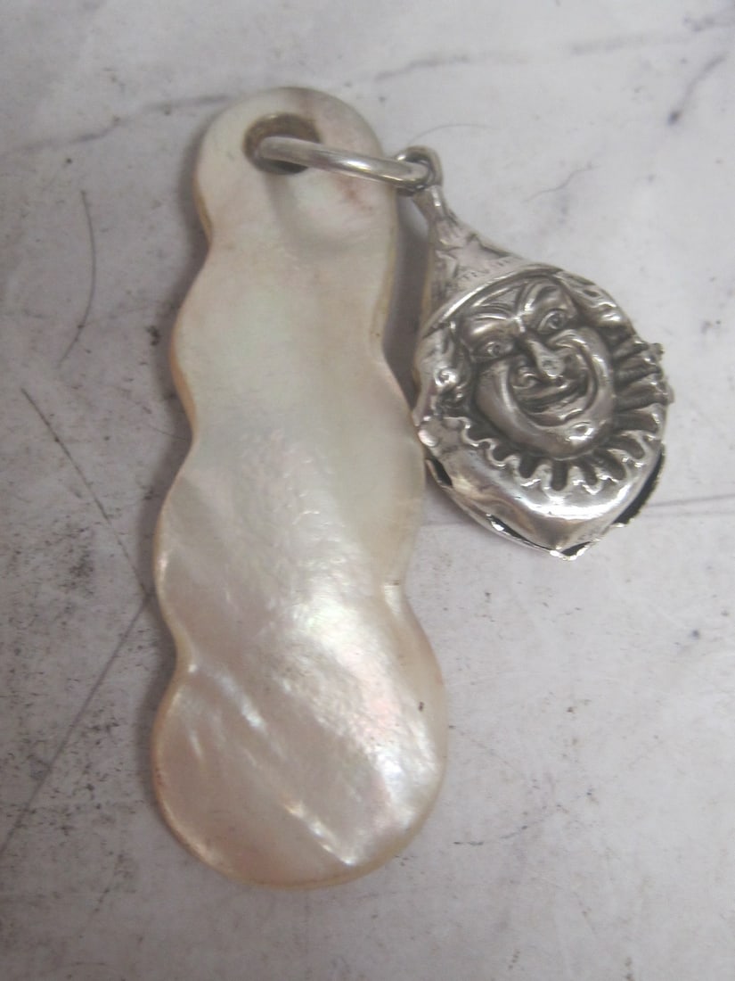Antique Sterling Silver Baby Rattle: Carved Mother of Pearl teething part, figural clown face as is, lacks bell, overall 4" 