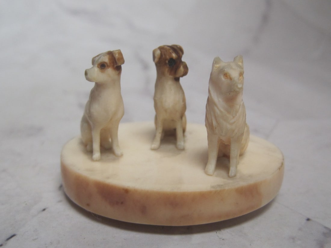 Wonderful Carved Figural Dog Group: A seated trio on oval base, 2" across, 1 1/8" tall 