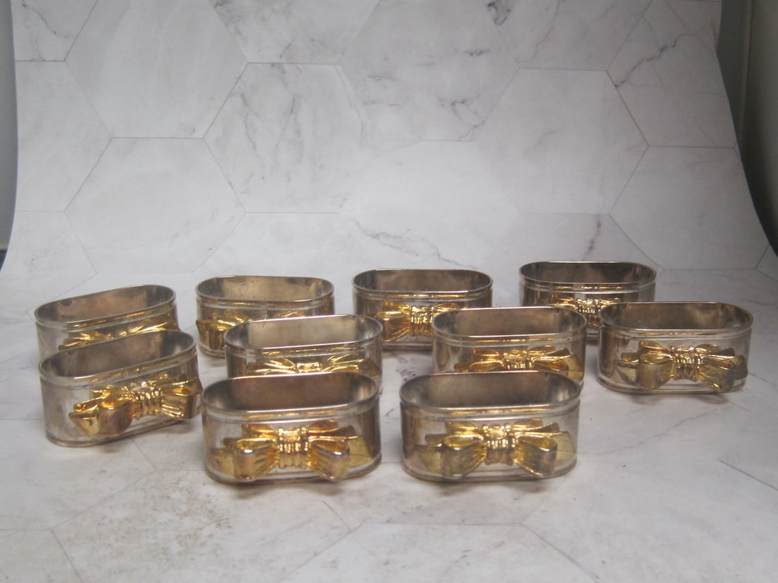Lot of 10 Napkin Rings: Silverplate with gold bows, oval, 2" wide 