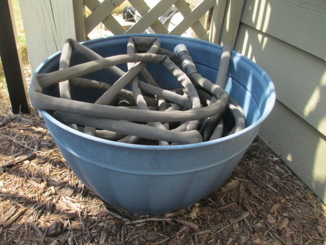Blue Metal Water Hose Planter with Black Water Hose with Nozzle: Hose planter 18 1/2"dia x 11 1/2"h, Local Pickup Only 