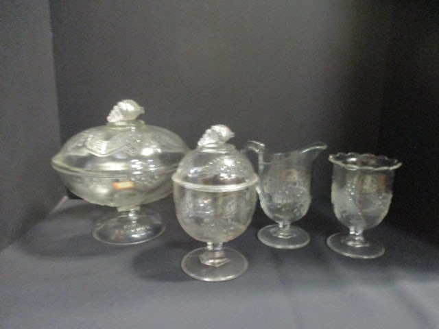 Early American Pressed Glass Barberry Covered Low Compote, Creamer, Sugar Bowl and Spooner: Low compote 8"h(some flea bite chips on lid and inside rim), Creamer 6"h, Sugar bowl 7 1/4"h(few small chips on under side lid rim), Spooner 5 1/4"h 