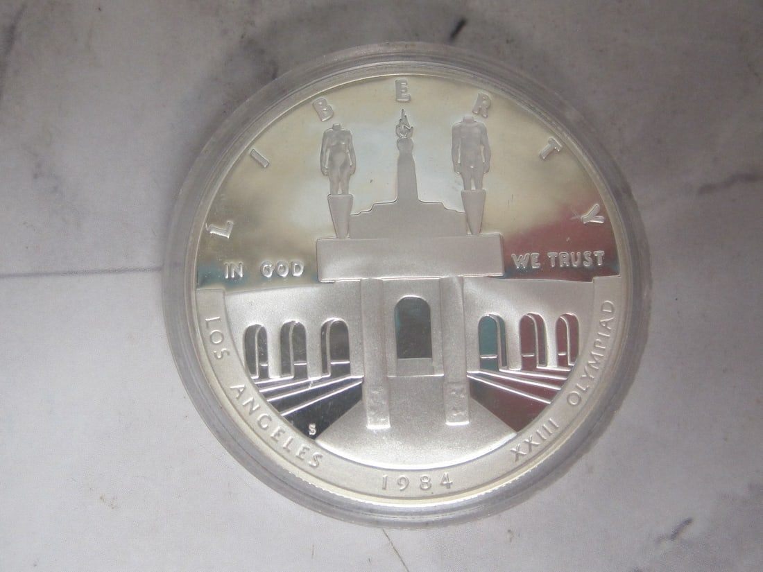 1984 US Olympic Proof Silver Dollar: Weighs 26.7 grams, 90% silver