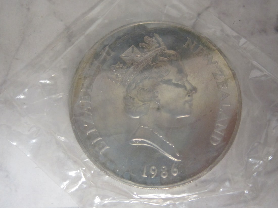 1986 New Zealand Royal Visit One Dollar Silver Proof Coin: Weighs 27.2 grams, 92.5% silver 