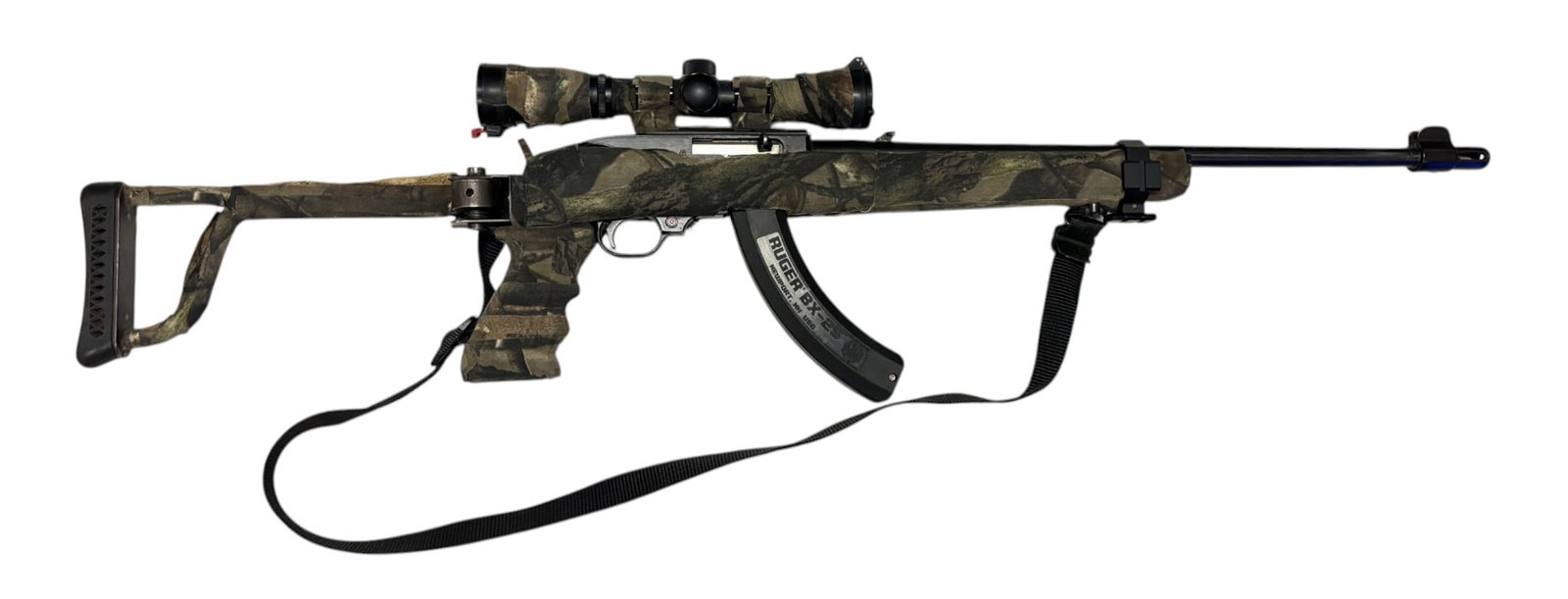 Ruger Model 10/22 .22 LR Semi-Automatic Rifle with Scope and Sling: S#: 233-85500 | Mfg. 1991 | 18.5" Barrel | Comes with (1) 25rd. Magazine | Features folding Paratrooper stock | Comes with Swift scope | Comes in Real Tree camo taped wrap|||| CONDITION: Good. Shows