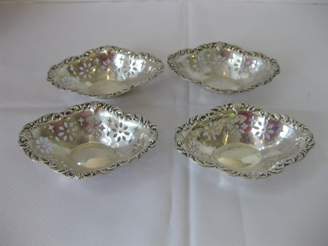 Four Vintage Austrian American Co. "AAA" Pierced Sterling Nut Dishes: 2.87 troy ounces total weight, each dish measures 4 1/4" x 3" x 1", marked three stacked triangles with an "A" over STERLING
