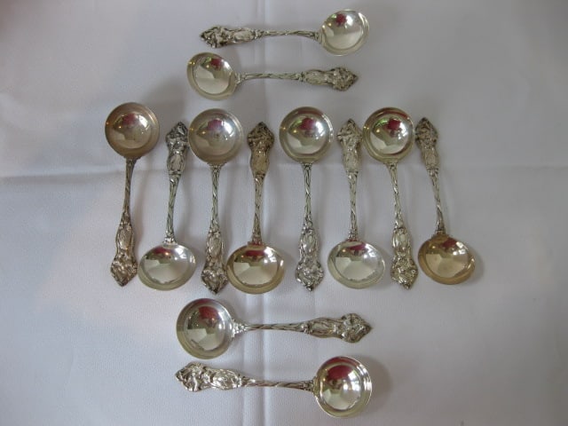Ten Vintage Victorian Sterling Cream Soup Spoons with Floral Design: 13.01 troy ounces total weight, each measures 5 3/8" long, have maker's mark and Sterling, handles have monogram, one spoon has tight crack-see pictures