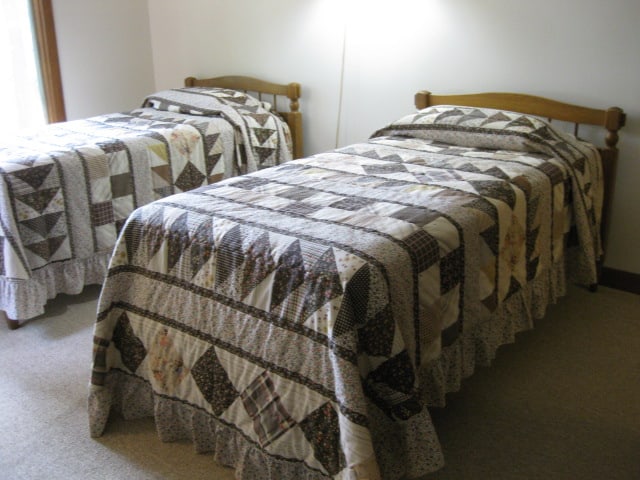 Pair of Wood Spindle Headboard Twin Beds with Wood Rails: Spindle headboards with raised panel design footboards, Includes Sealy mattress and box springs, sleeping pillows and bedspreads, Located Downstairs-Gradual sloping back and side yard to carry around