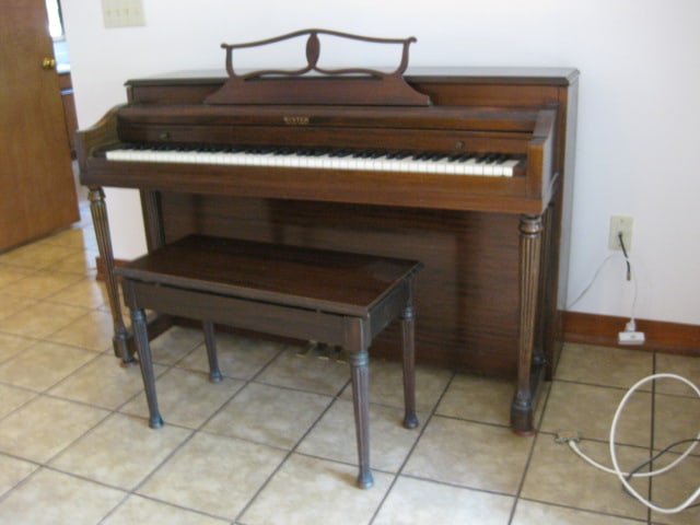 Winter Co. New York, NY Mahogany Upright Piano and Bench: Piano 56 3/4" x 24 1/4" x 37 1/2", Bench 30" x 14" x 20", Piano Serial #313125, piano has casters, bench has under seat storage with song books and sheet music, Piano is Located Downstairs-Gradual Slo