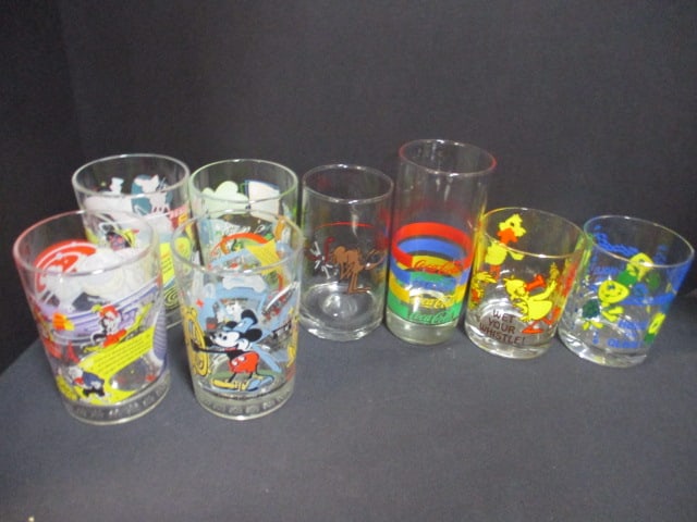 4 Walt Disney World Collector's Glasses, 2 J.Cleveland Glasses, Coca-Cola: "Rainbow" Glass, and Arby's "Ice-Age" Glass, 4 1/2" to 6 1/2"