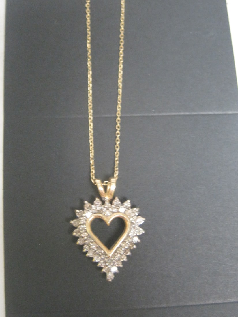 10k Gold Diamond Heart Pendant on 16" 10k Gold Chain: 46 Round Diamonds Totalling 1.50 Carat. Fancy Champagne Color, Appraised at $1950. See Appraisal Photos for Specs