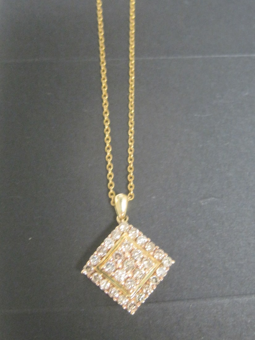 14k Gold Diamond Pendant on 22" 14k Gold Chain: 29 round diamonds totalling 1 Carat, Fancy Champagne color. Appraised at $1450. See Appraisal Photos for Specs