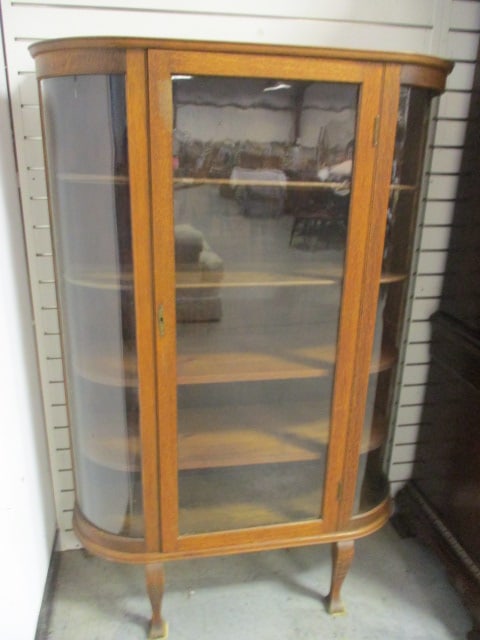 Antique Oak Curved Glass Curio Cabinet: 39" x 13 1/4" x 59", has four shelves(two are original with plate grooves), door has lock but no key, Local Pickup Only