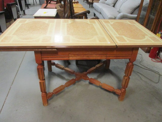 Vintage Draw Leaf Enamel Top Kitchen Table with Drawer: 42" x 32" x 31 1/4"(leaves up), (leaf open)62 1/2" x 32" x 31 1/4", divided flatware drawer, cross base has some finish scuffs and nicks, top in good condition-slight design wear on one section, Local