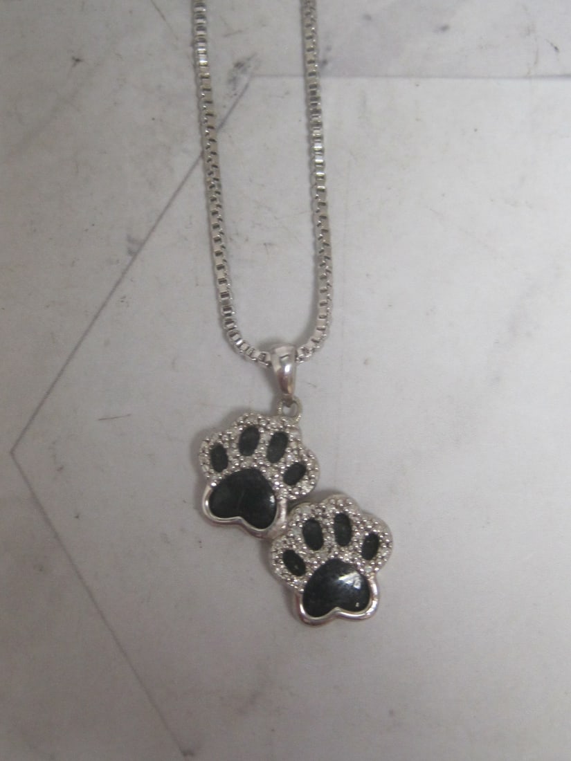 Sterling Silver Black Onyx & Diamond Double Paw Print Pendant on 16" Sterling Silver Chain: Weighs 6 grams, 1/10 ct tw. Diamond, purchased at Kay Jewelers for $399