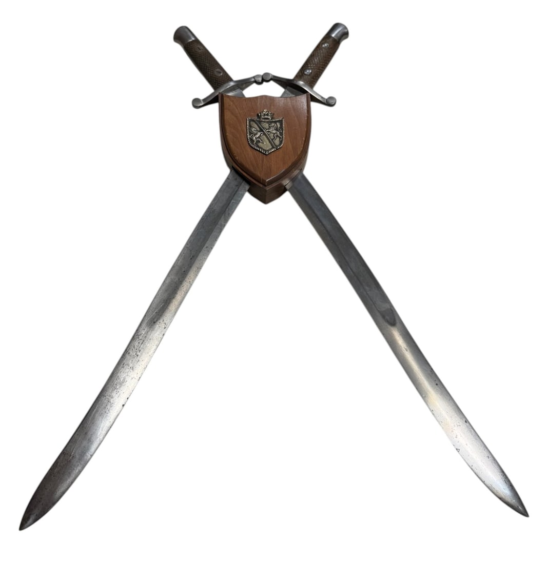 Art Fab De Toledo 1890 and 1893 Dated Spanish Swords in Wall Hanging Cross: 23.25” blade and 28.25” overall length. Original swords in an aftermarket display to hang on the wall.