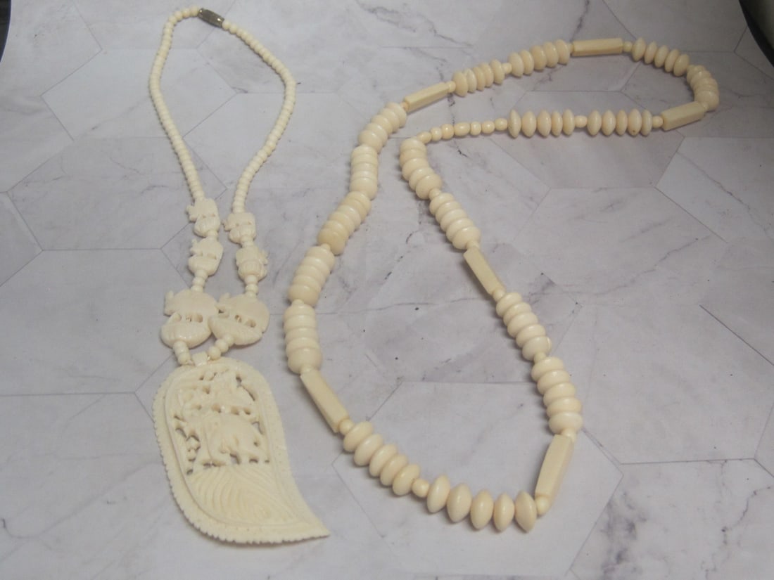 Lot of 2 Carved Tribal Style Necklaces: .