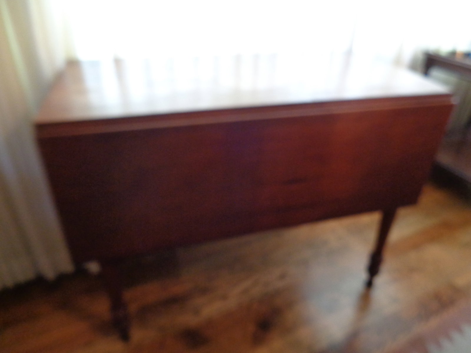 Vintage Wooden Drop Leave table, Turned Legs: some wear, swing out Leaf Supports, scratches. Top 45 in open, 29 tall 38 long