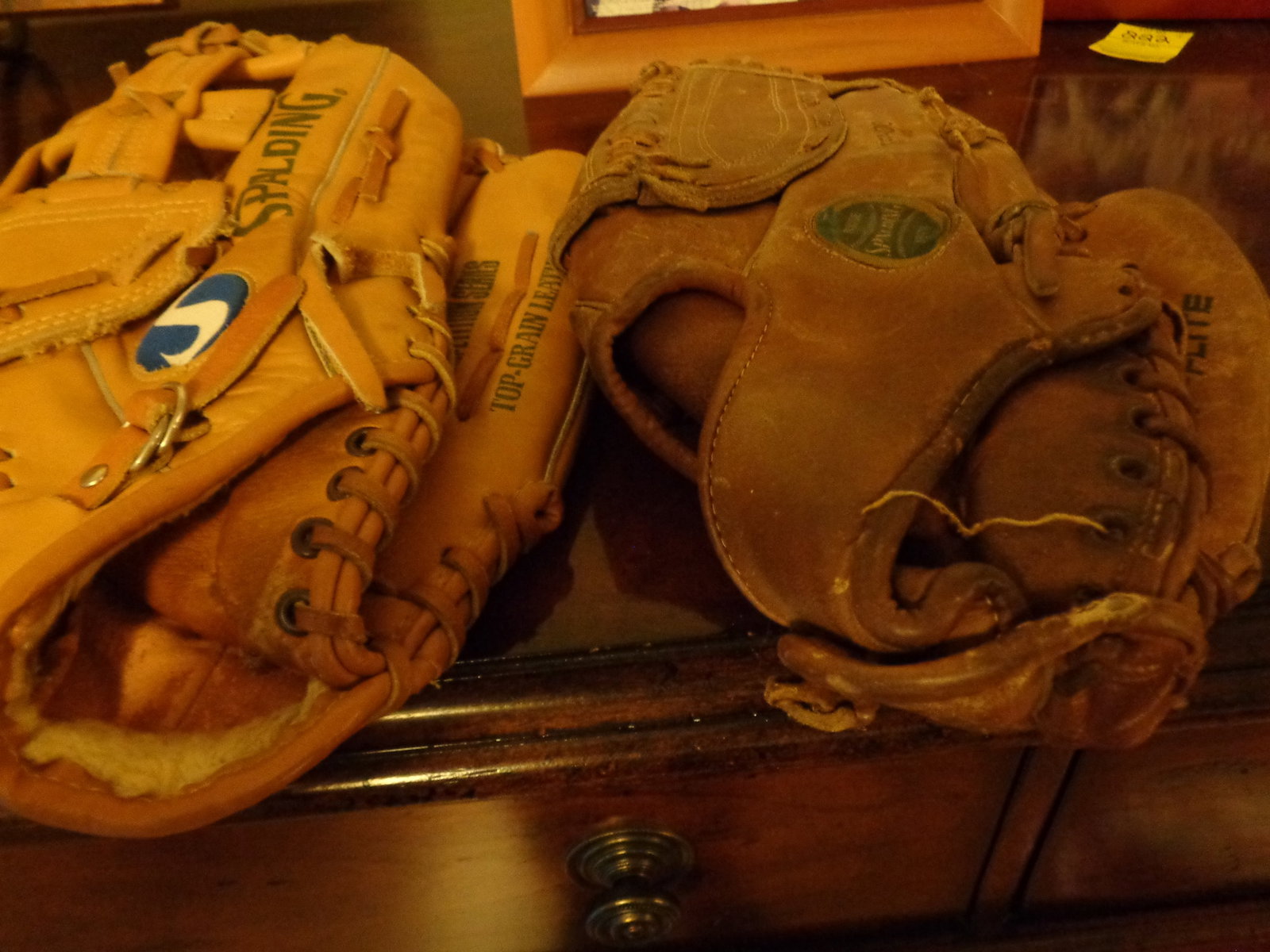 2 older baseball gloves: Spaulding Adult
