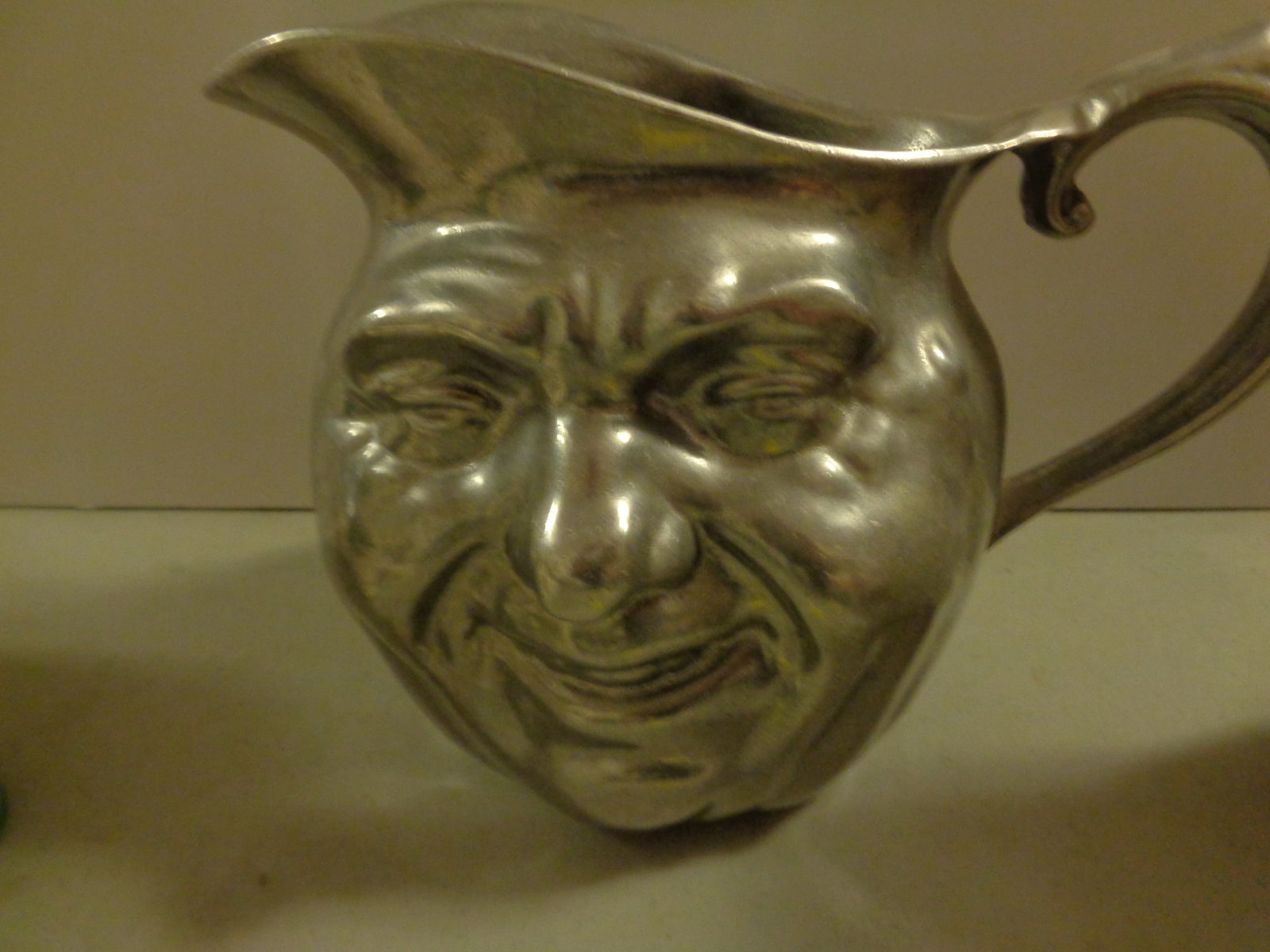 Vintage Silver Tone Metal Face Pitcher: 6 1/2 inches