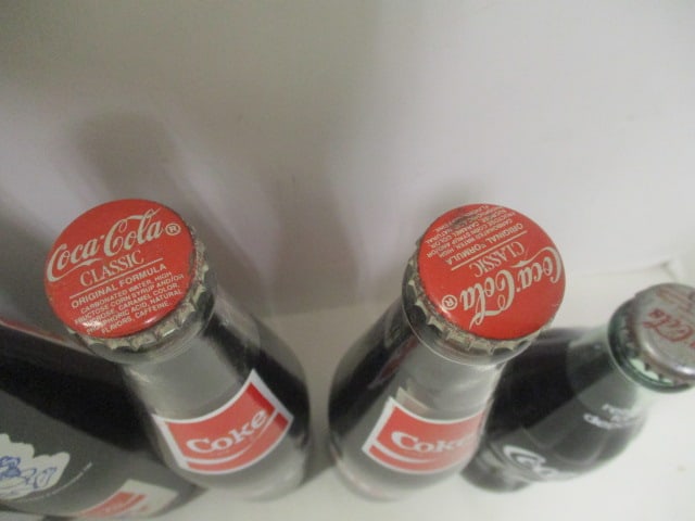 Grouping of 7 Unopened Commemorative Coca-Cola Bottles - Furman, Olympics, - 8
