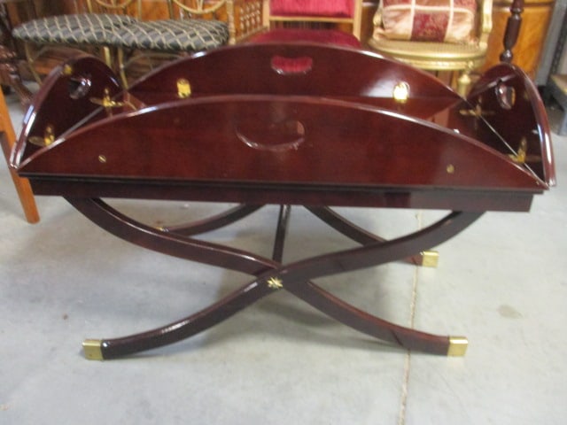 Bombay Mahogany Butler's Table with Cross Base: 35" x 20" x 23 1/2" measurements with sides up, 45 1/4" x 30 1/4" x 18 1/4" measurements with sides down, brass feet, few small finish chips, Local Pickup Only