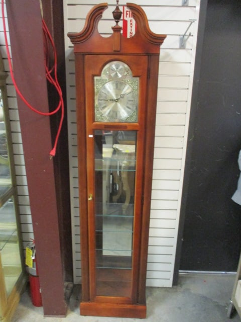 Howard Miller "Tempus Fugit" Quartz Display/Curio Case Floor Clock: Model #610-614, Serial #MF0024010376, 19 1/4" x 10 3/4" x 77", Locking door with key, three glass shelves, mirror back, untested needs battery, Local Pickup Only
