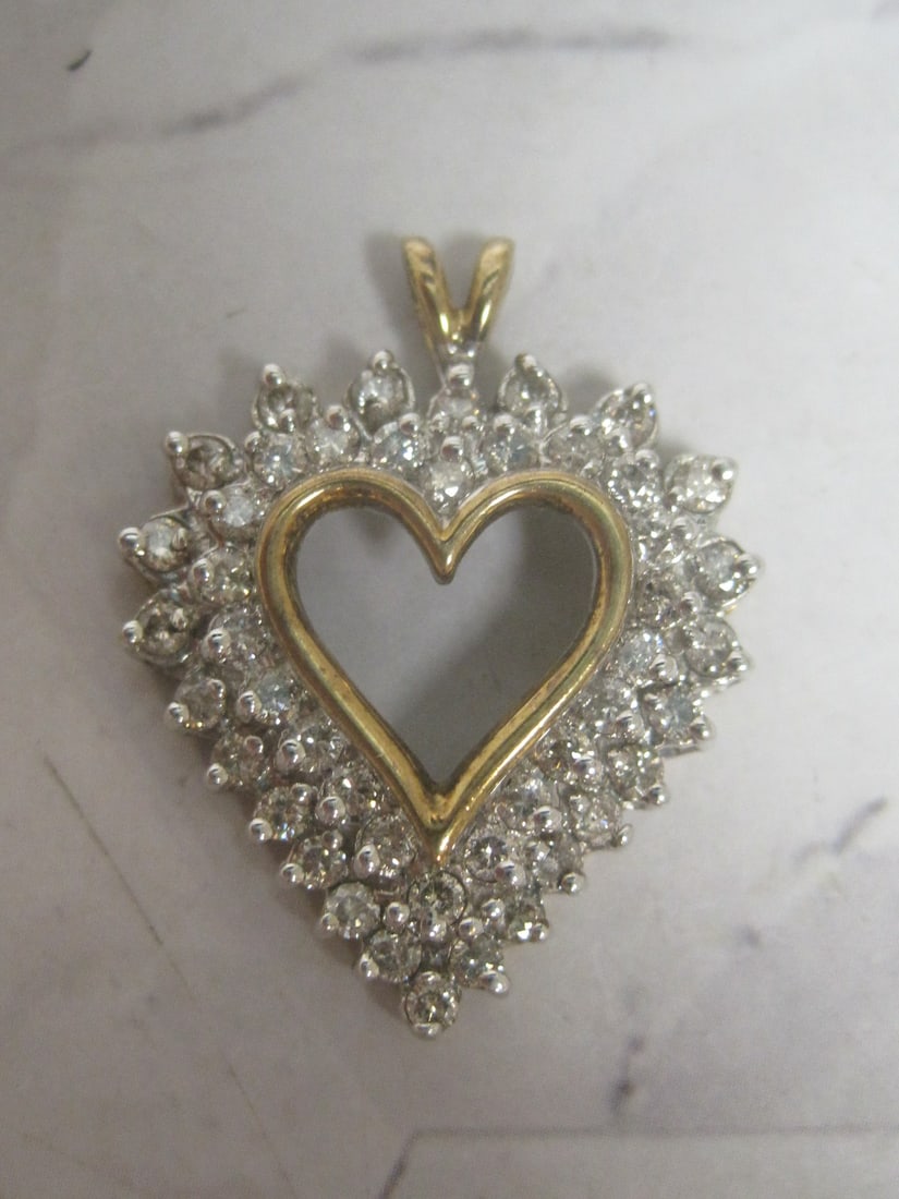 14k Gold Diamond Heart Pendant appraised at $2000: Weighs 4 grams, 1", 1 carat total, 47 round diamonds, 14k white & yellow gold. See picture of appraisal for additional info.