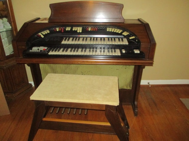 Late 1960's Conn "Theatrette" Electric Organ and Bench: Model 552, Serial #565861, Style 001, Finish 033, Organ 46" x 23 1/2" x 38 1/2", Bench 36 1/2" x 14 1/2" x 22 1/2", powers on, has song book and instructions, speaker fabric has some tears and loose
