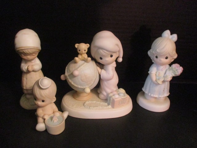 Four Enesco Precious Moments Figurines: 1987 "I Would Be Sunk Without You" #102970, 1993 Special Limited Edition "You're My Number One Friend" #530026, 1987 "Thanking Him for You" #E-7155 and 1991 "May Your World Be Trimmed with Joy" #52208