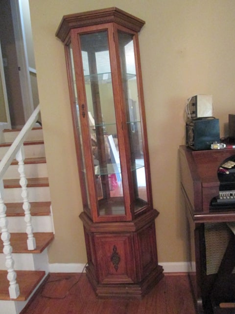Pulaski Oak Veneer Illuminated Curio Display Cabinet with Angled Sides: 25" x 10 3/4" x 71 3/4", glass sides and front, mirrored back and shelves, bottom storage, one piece cabinet, Local Pickup Only