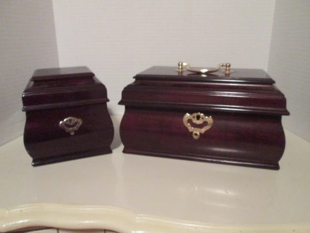 The Bombay Co. His and Hers Mahogany Jewelry Box Set: "His" valet box 5 1/2" x 5 3/4" x 5 5/8", "Her" box 10 1/4" x 6 1/4" x 5 1/2", both have locks and keys