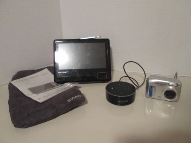 Olympus FE-100 Digital Camera, Amazon Dot Model RS03QR and Eviant Model 17: 7" Portable Digital TV with Remote. All untested-TV needs power cord