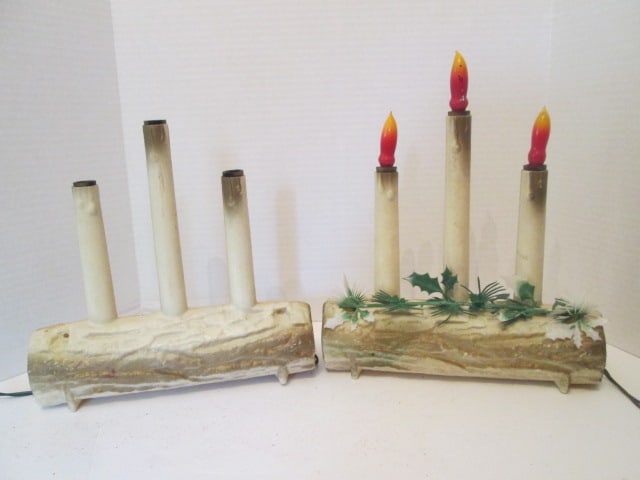Pair of Vintage Electric Yule Log Molded Lights: 10 1/2" long, 10 1/2"h, one is missing holly strand, both work, light without holly all three lights lit up when initially plugged, then one went out. Bulbs work so wire may be loose